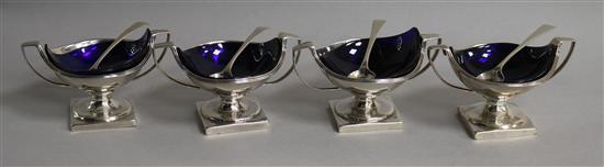 A matched set of four (two pairs) George III silver two handled circular pedestal salts,